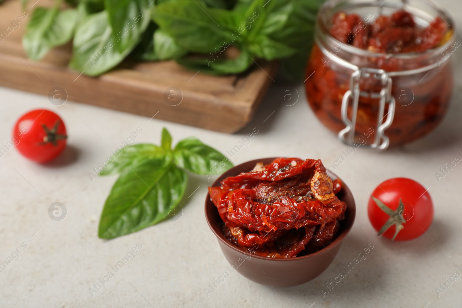 Photo of Dried tomatoes in bowl on table. Healthy snack