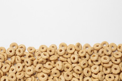 Photo of Sweet tasty corn rings on white background, top view