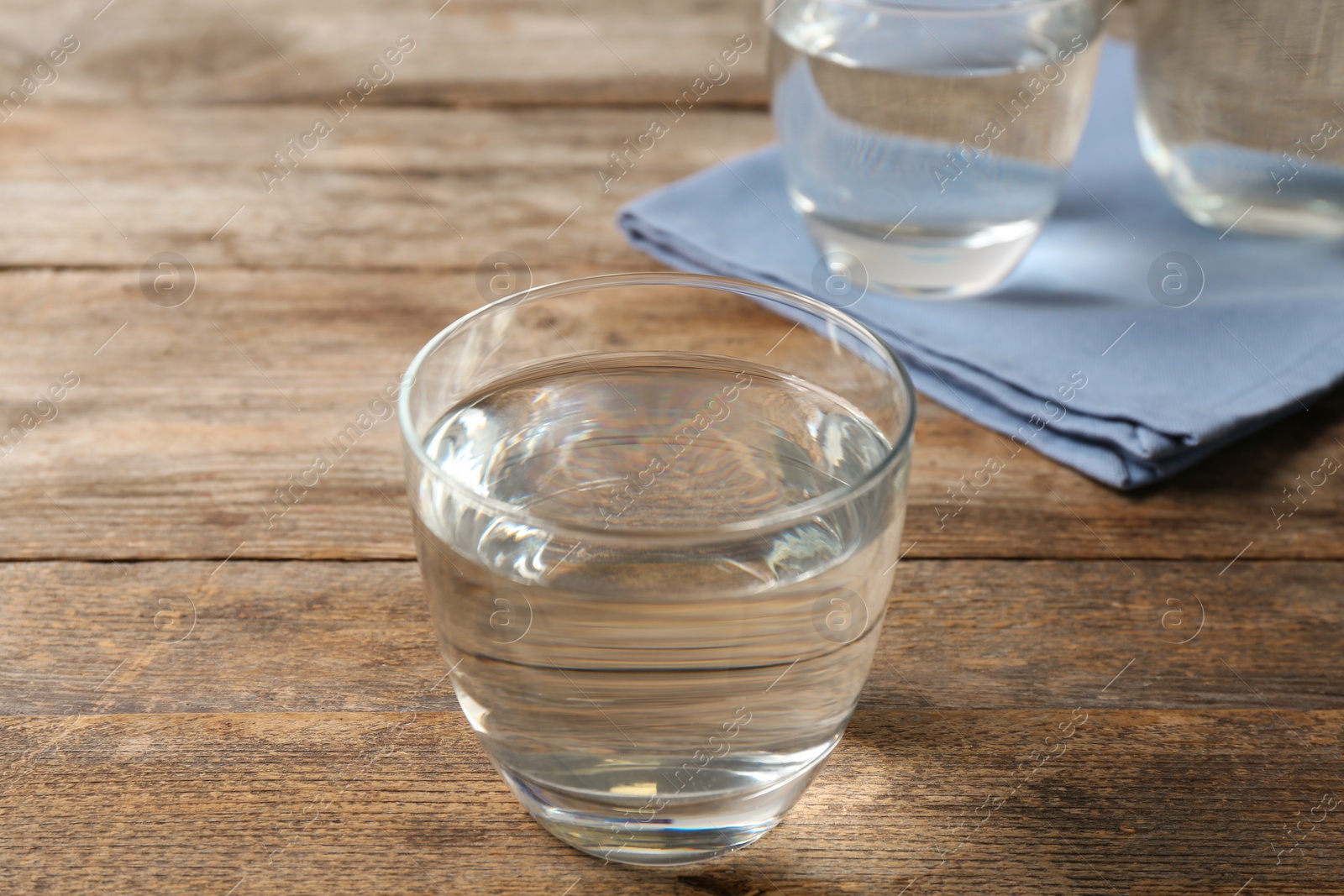 Photo of Glass of fresh water on wooden table