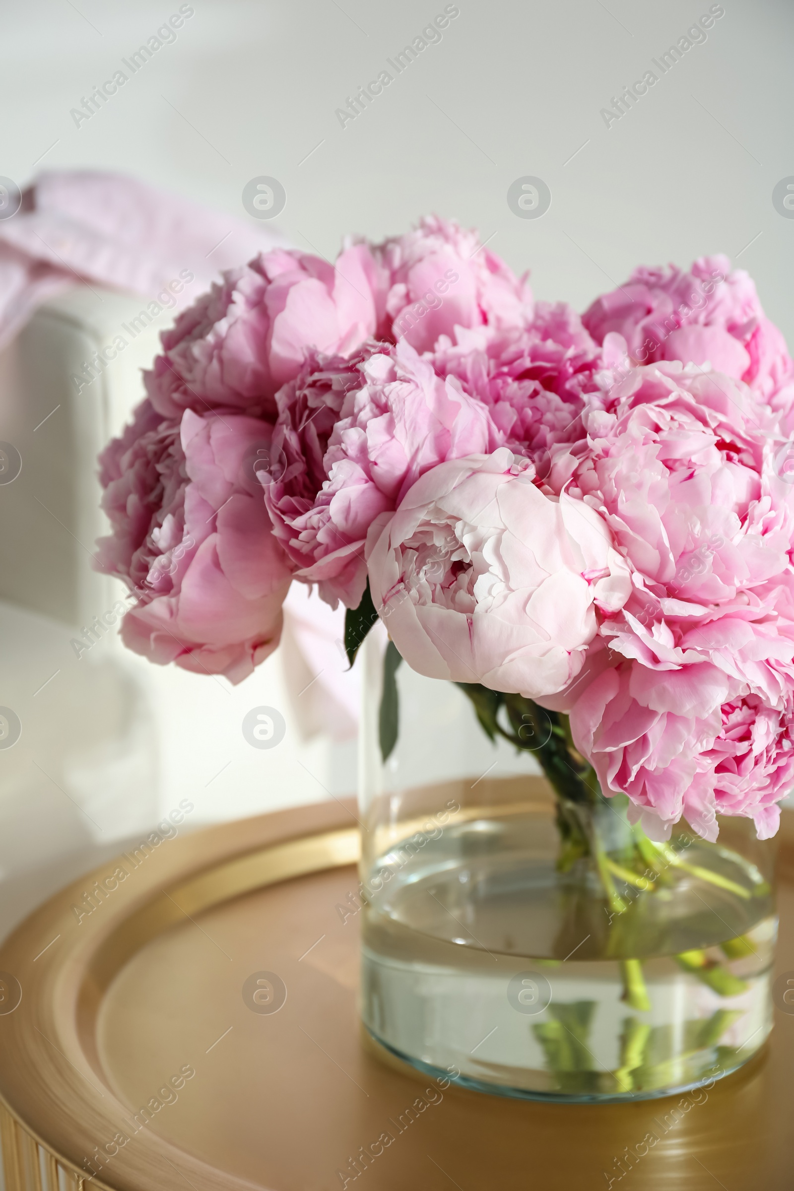 Photo of Bouquet of beautiful peonies on table indoors