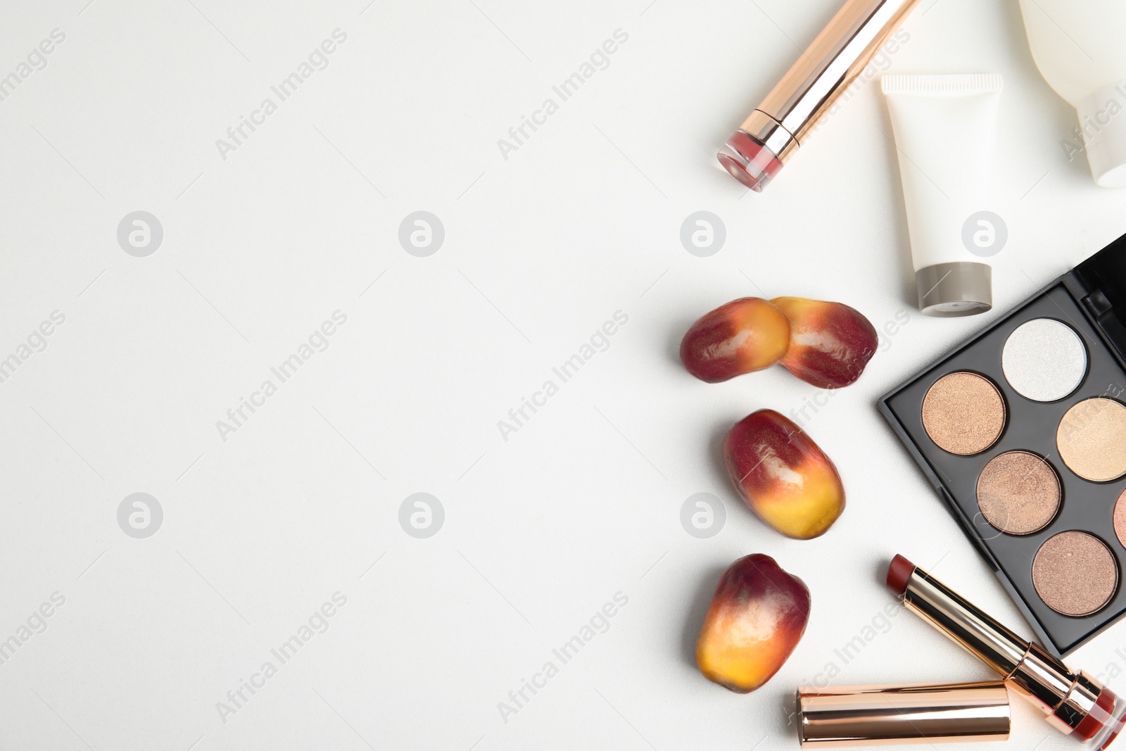 Image of Fresh ripe palm oil fruits and cosmetic products on white background, flat lay. Space for text