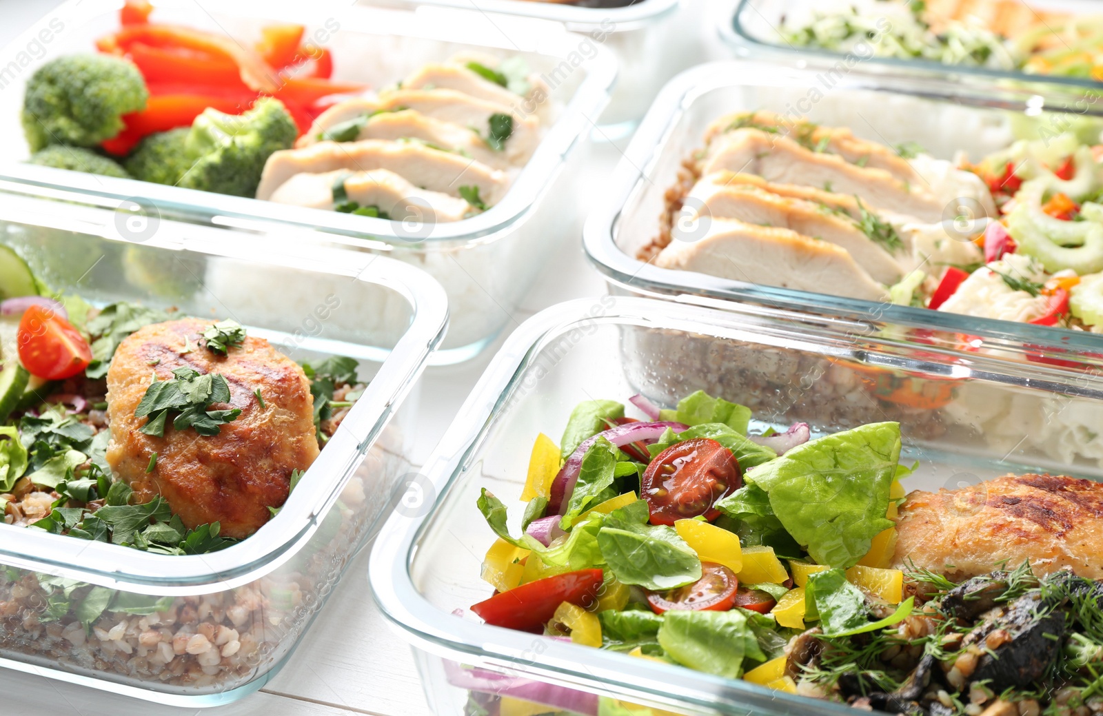 Photo of Healthy meal. Containers with different products on white wooden table, closeup