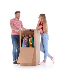 Photo of Young couple near wardrobe box on white background