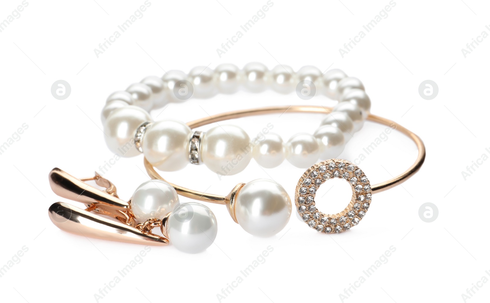 Photo of Different elegant jewelry with pearls on white background