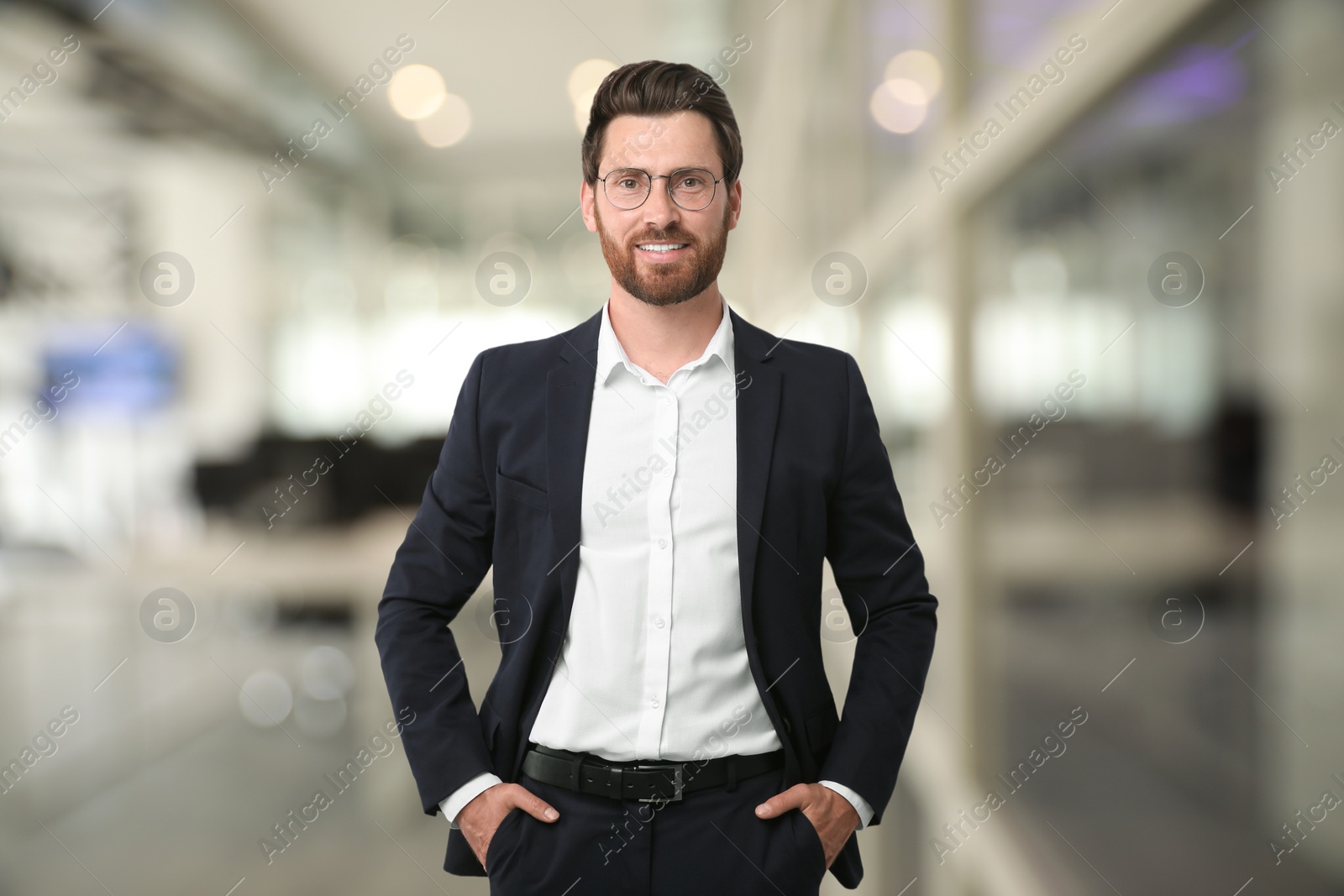 Image of Handsome confident man with eyeglasses in office