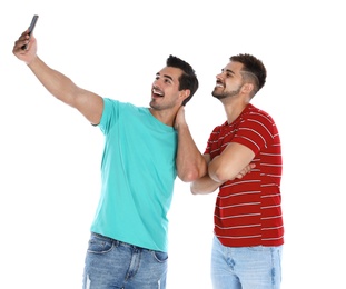 Photo of Happy young men taking selfie on white background