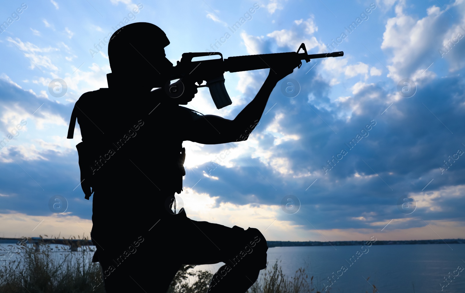 Photo of Soldier with machine gun patrolling outdoors. Military service