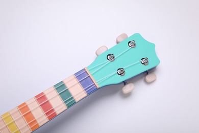 Photo of Colorful ukulele neck on white background. String musical instrument