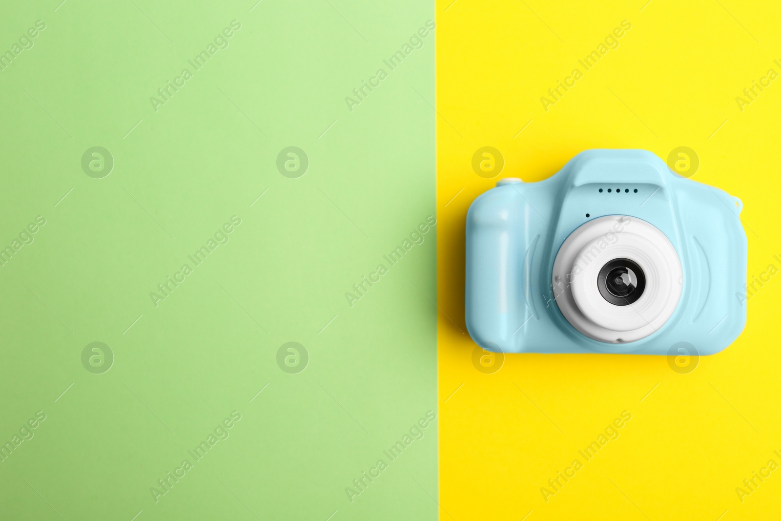 Photo of Light blue toy camera on color background, top view with space for text. Future photographer