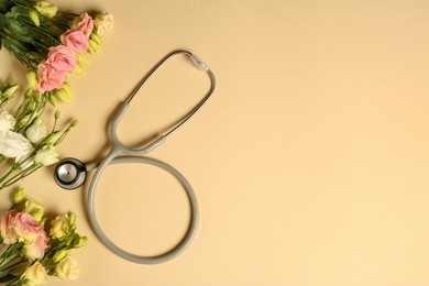 Photo of Stethoscope and eustoma flowers on beige background, flat lay with space for text. Happy Doctor's Day
