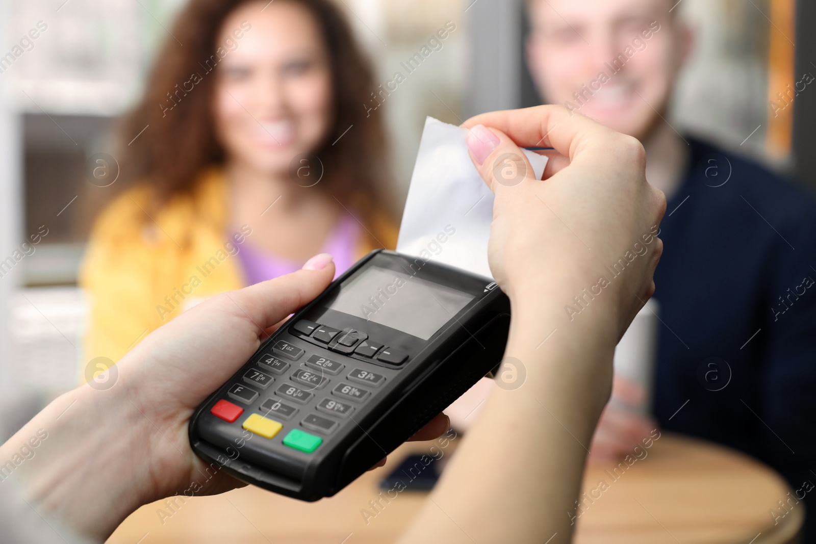 Photo of Clients using credit card machine for non cash payment in cafe, closeup