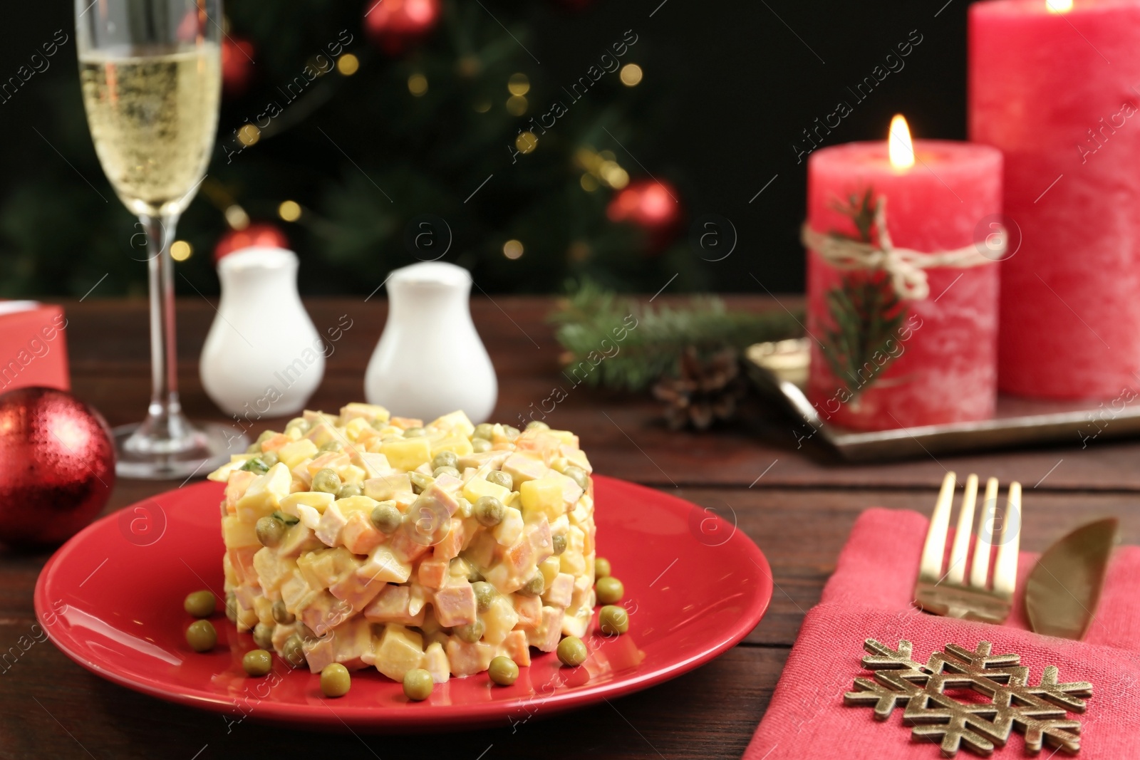 Photo of Fresh Russian salad Olivier served on wooden table