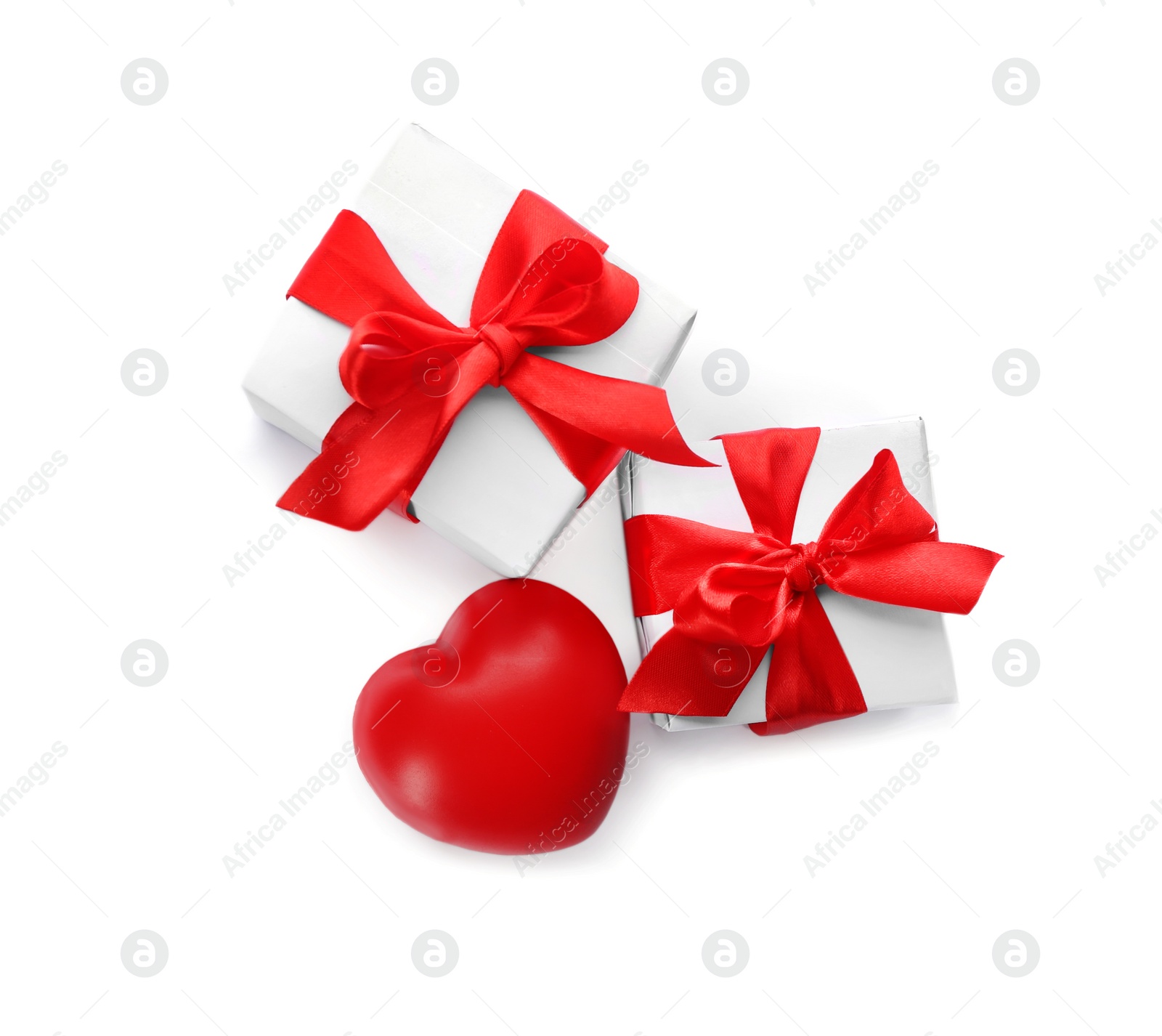 Photo of Gift boxes and red heart on white background, top view. Valentine's Day celebration