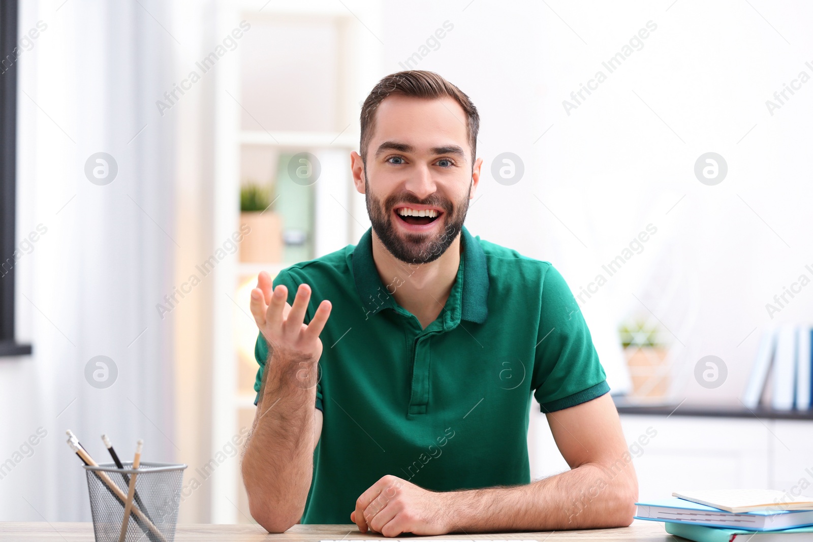 Photo of Handsome man using video chat for conversation indoors