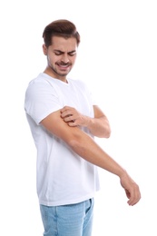 Photo of Young man scratching arm on white background. Annoying itch