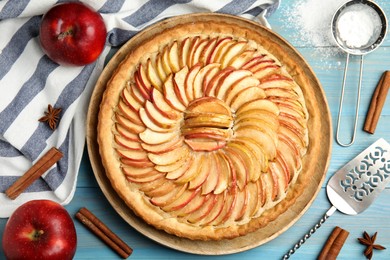 Flat lay composition with delicious homemade apple tart on light blue wooden table