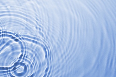 Image of Rippled surface of clear water on light blue background, top view