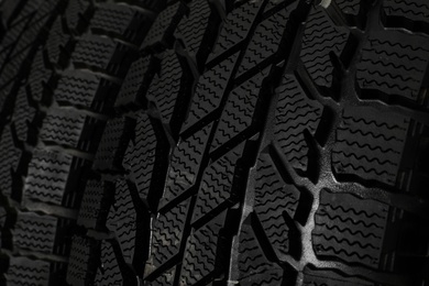 Photo of Set of new winter tires as background, closeup