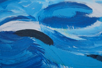 Photo of Beautiful strokes of blue oil paints on white canvas as background, closeup