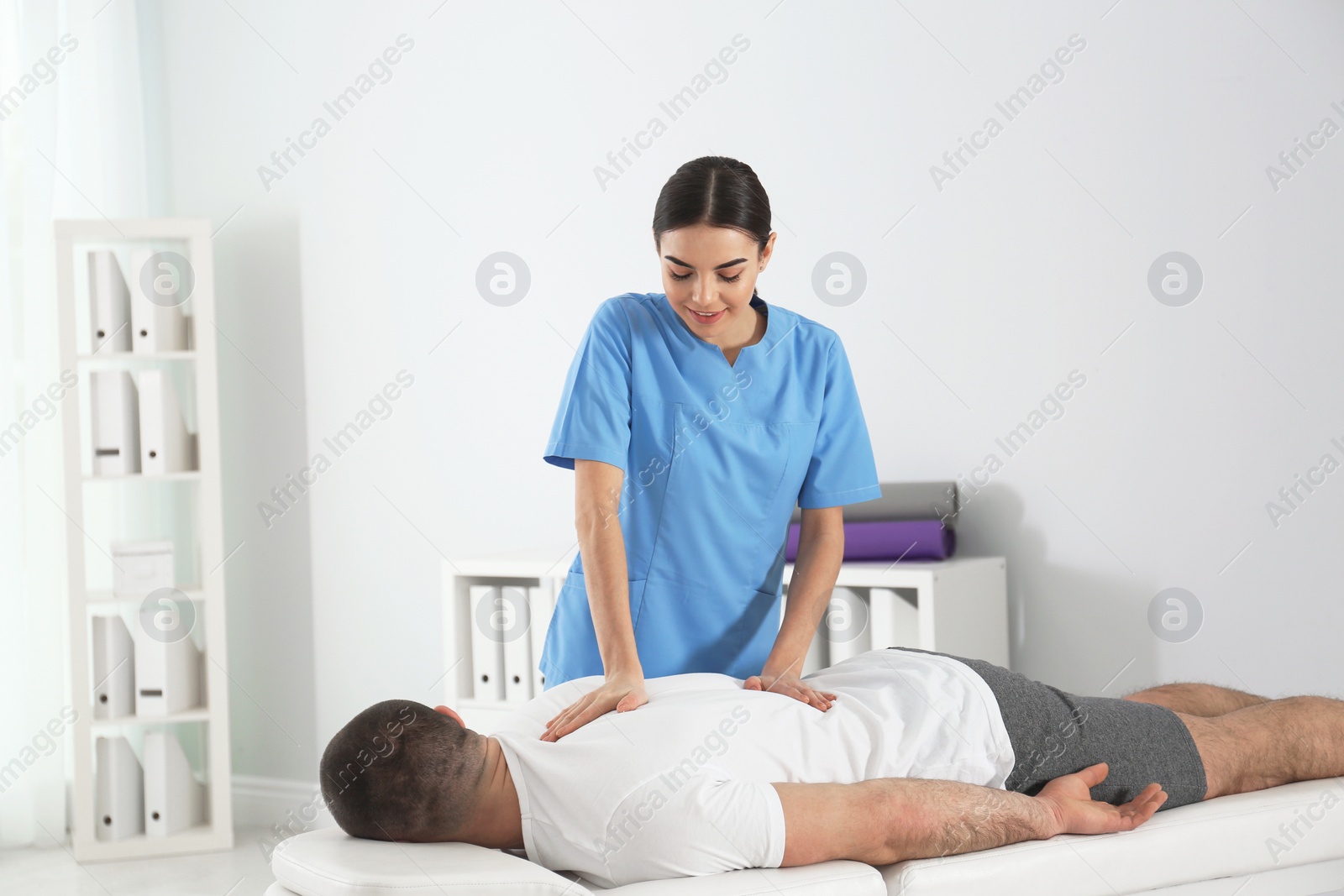 Photo of Doctor working with patient in hospital. Rehabilitation massage