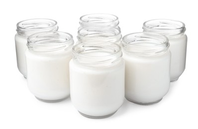 Photo of Glass jars with delicious homemade yogurt on white background