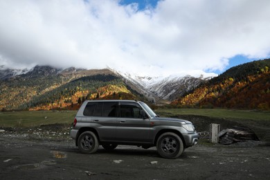 Picturesque view of modern car in beautiful mountains on autumn day