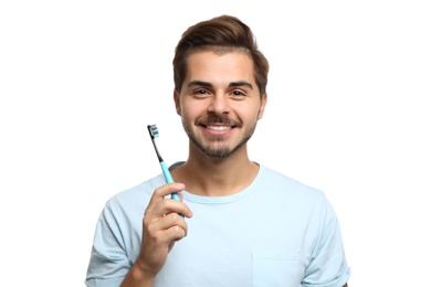 Photo of Portrait of young man with toothbrush on white background