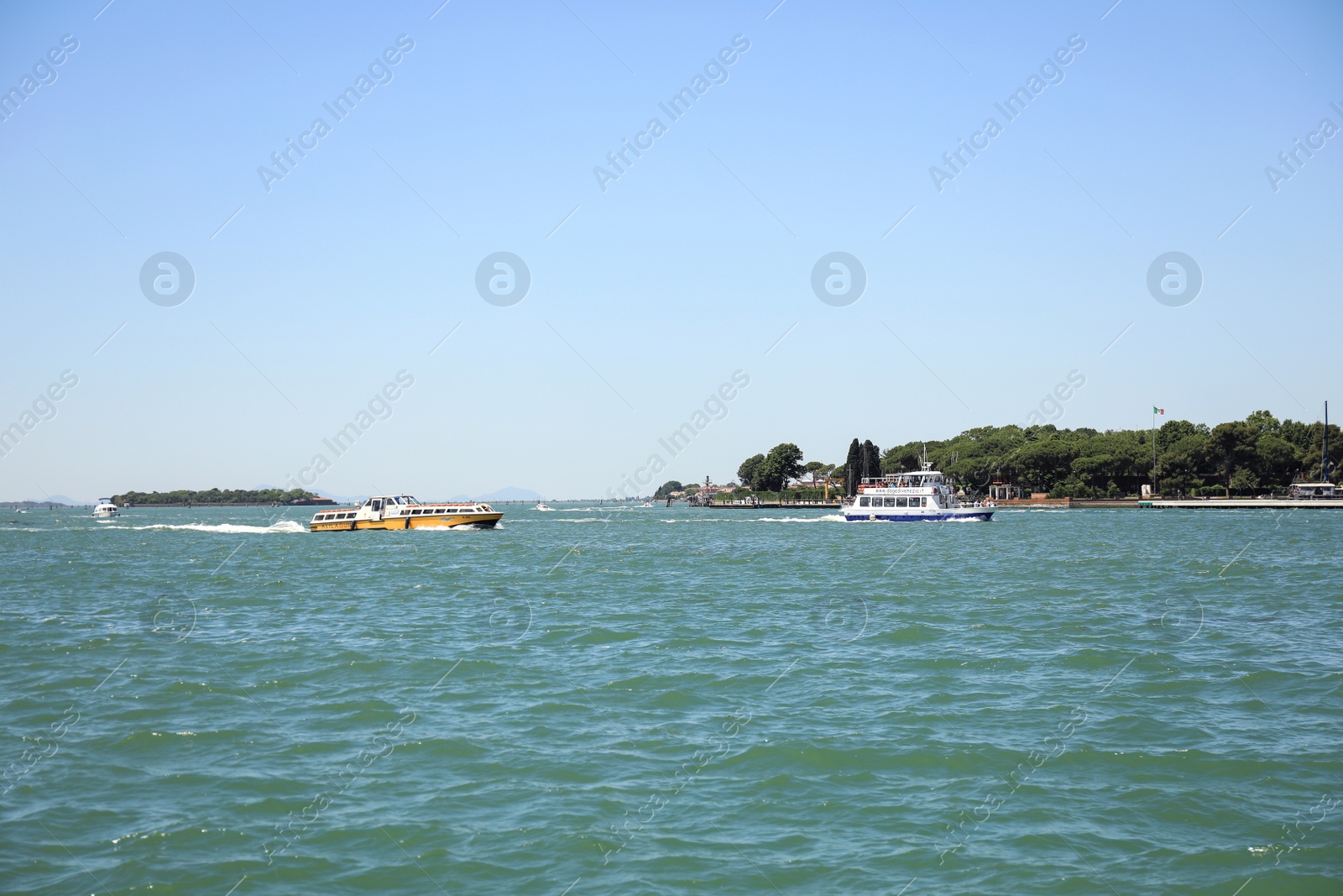 Photo of VENICE, ITALY - JUNE 13, 2019: Picturesque seascape with coastline and boats