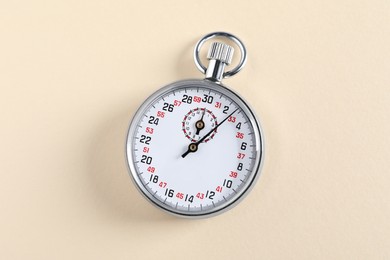 Photo of Vintage timer on beige background, top view. Measuring tool