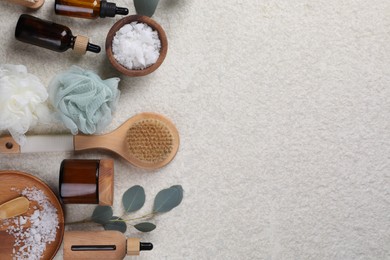 Photo of Flat lay composition with different spa products and eucalyptus branch on light grey textured table. Space for text