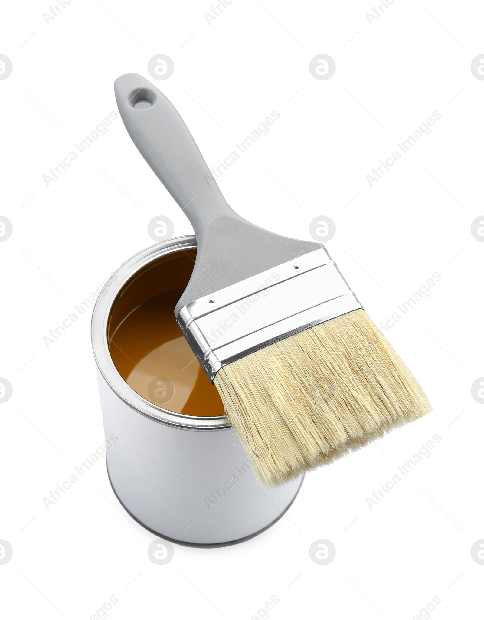 Photo of Can of yellow paint with brush isolated on white