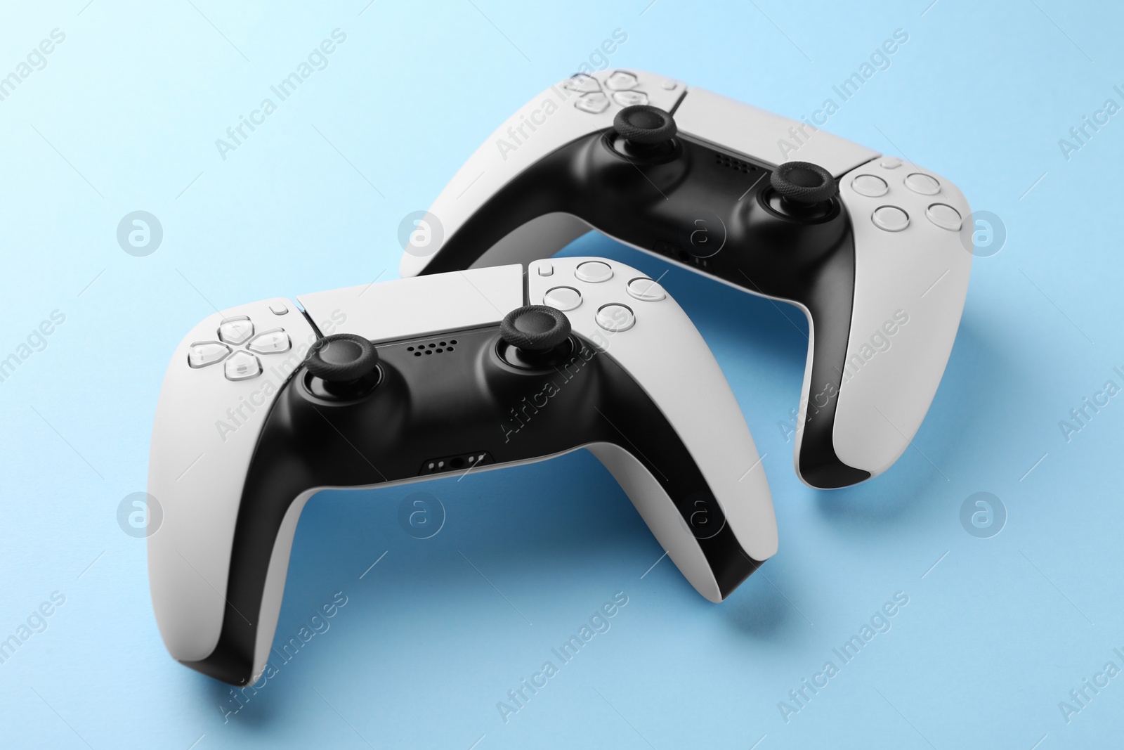 Photo of Wireless game controllers on light blue background