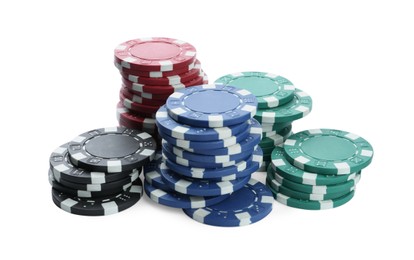 Photo of Plastic casino chips stacked on white background. Poker game