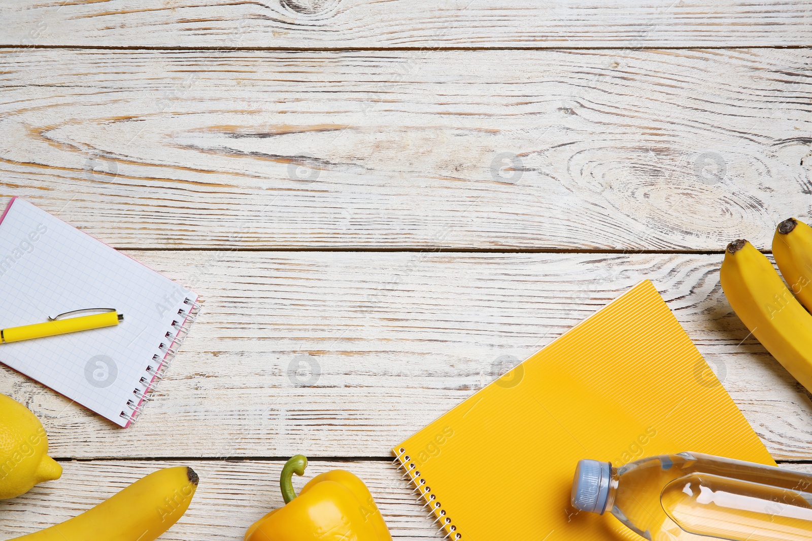 Photo of Flat lay composition with healthy food, notebooks and space for text on wooden background. Weight loss concept