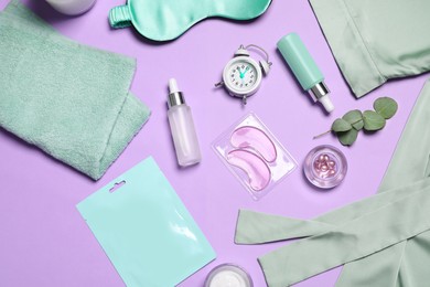 Flat lay composition with sleeping mask and skin care products on violet background