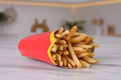 MYKOLAIV, UKRAINE - AUGUST 12, 2021: Big portion of McDonald's French fries on marble table in kitchen, closeup