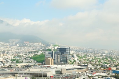 Photo of Picturesque view of cityscape with many buildings near mountain