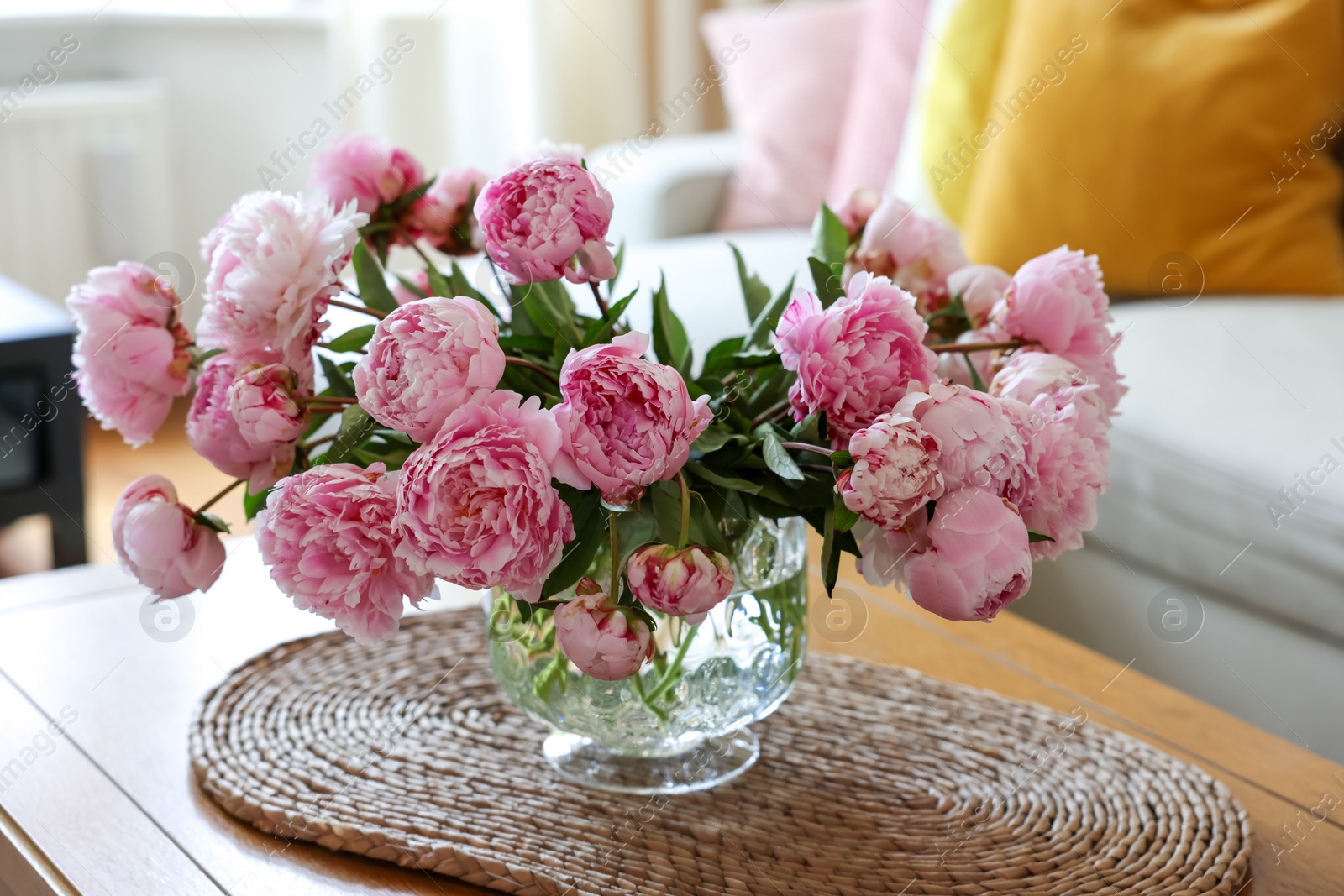 Photo of Beautiful pink peonies in vase on table at home. Interior design