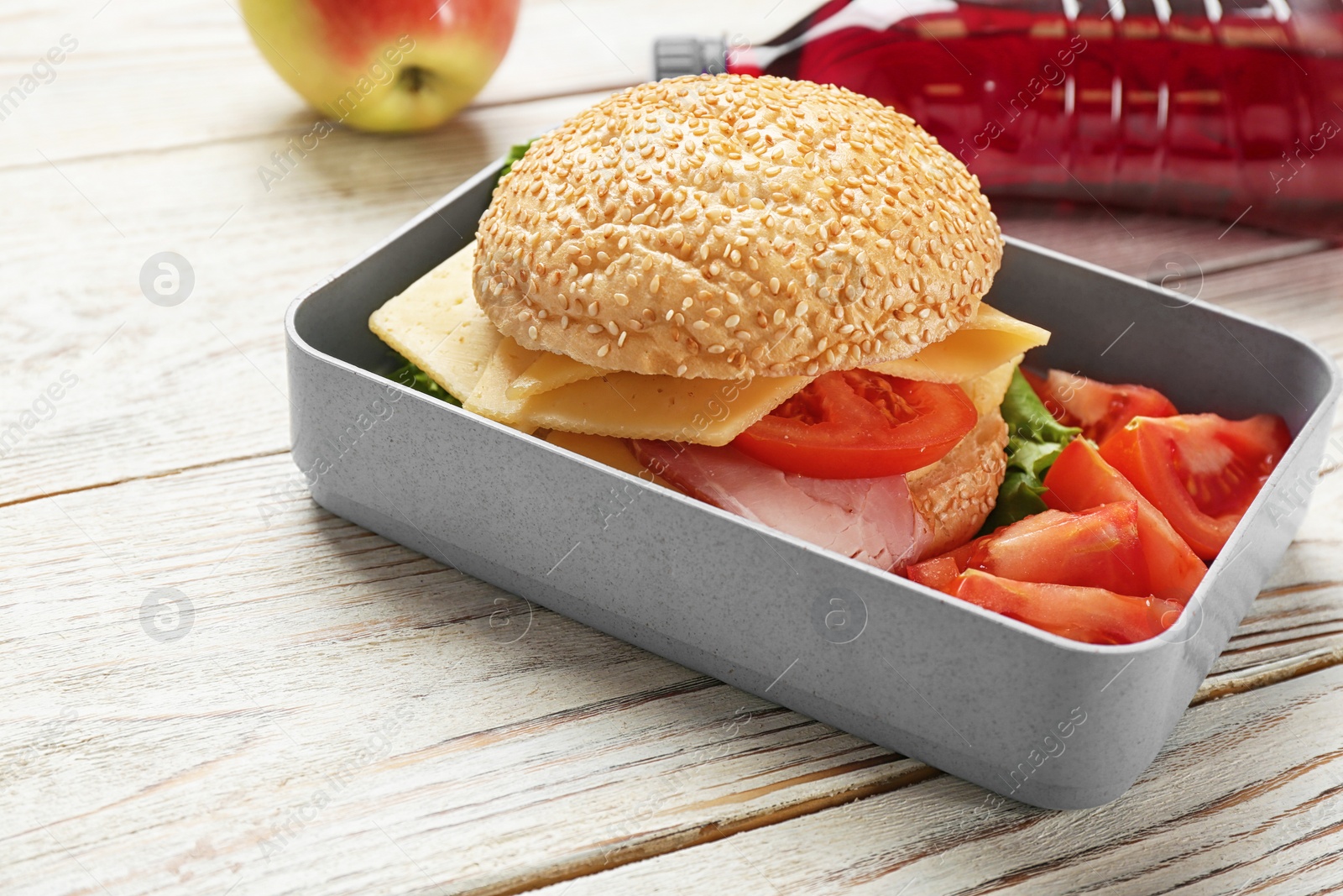 Photo of Lunch box with tasty sandwich on wooden table