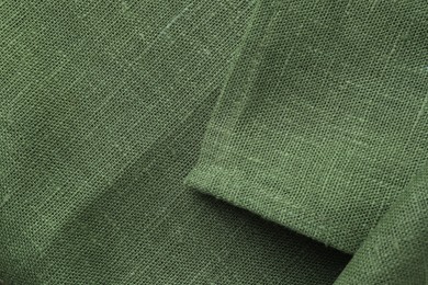 Photo of Texture of green fabric as background, top view