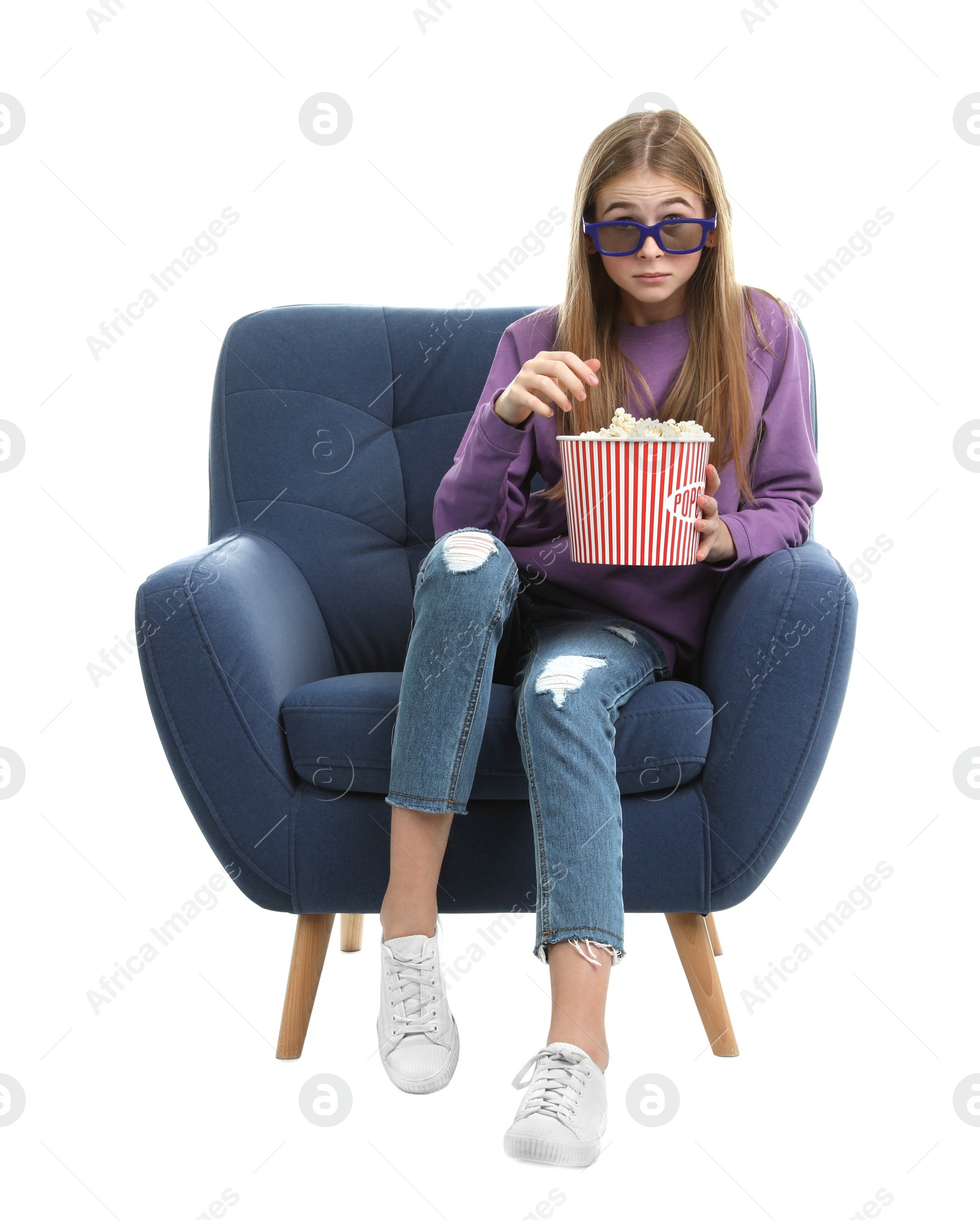 Photo of Emotional teenage girl with 3D glasses and popcorn sitting in armchair during cinema show on white background
