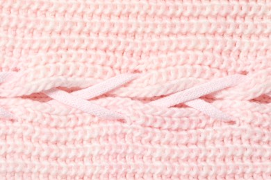 Photo of Texture of soft pink knitted fabric as background, top view