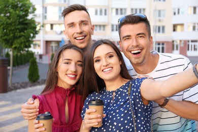 Group of young people taking selfie outdoors