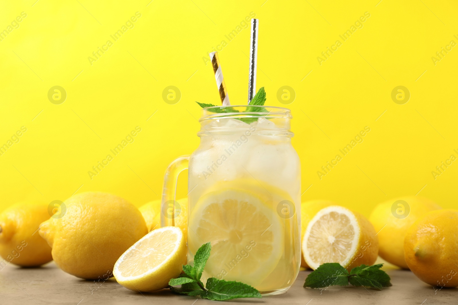 Photo of Natural freshly made lemonade with mint on light grey table. Summer refreshing drink