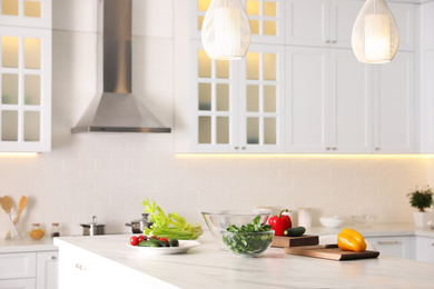 Photo of Fresh vegetables for salad on modern kitchen island