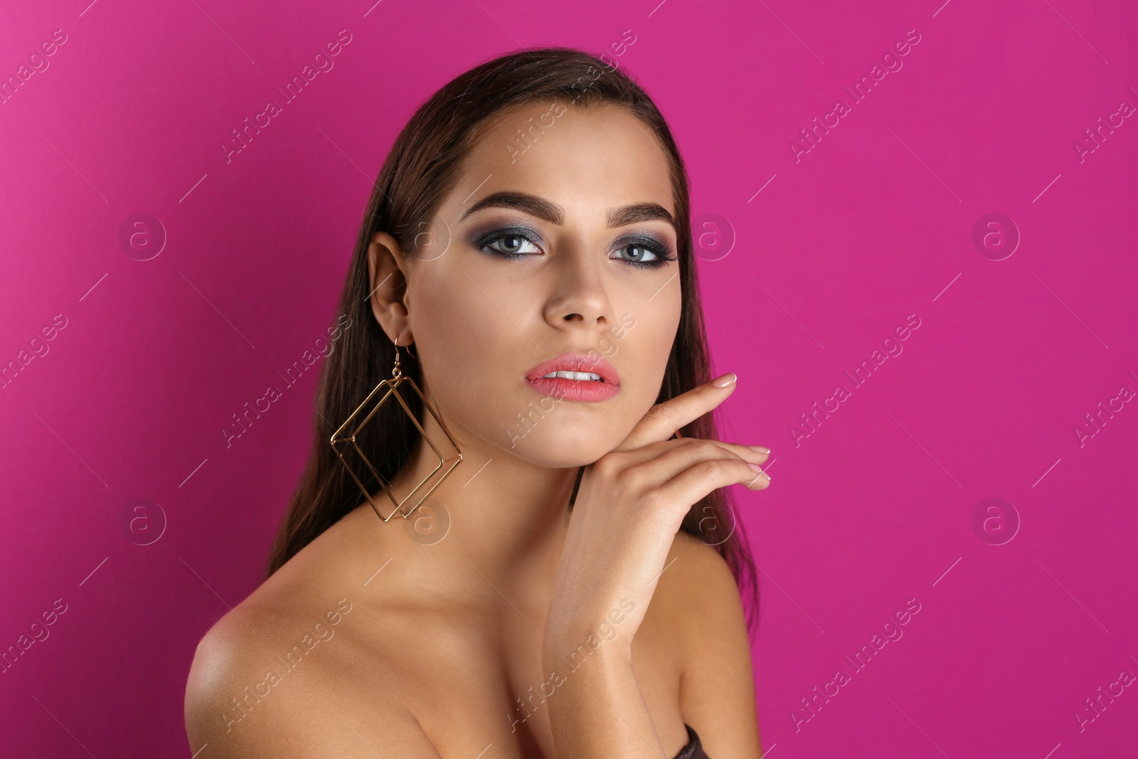 Photo of Portrait of beautiful woman with stylish makeup on color background