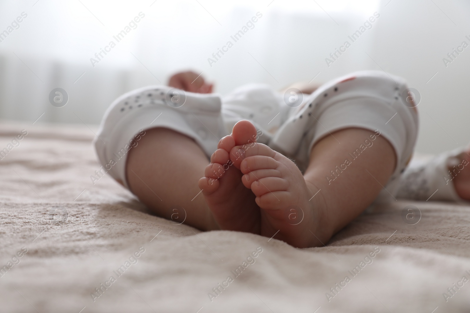 Photo of Little baby on brown blanket at home, closeup