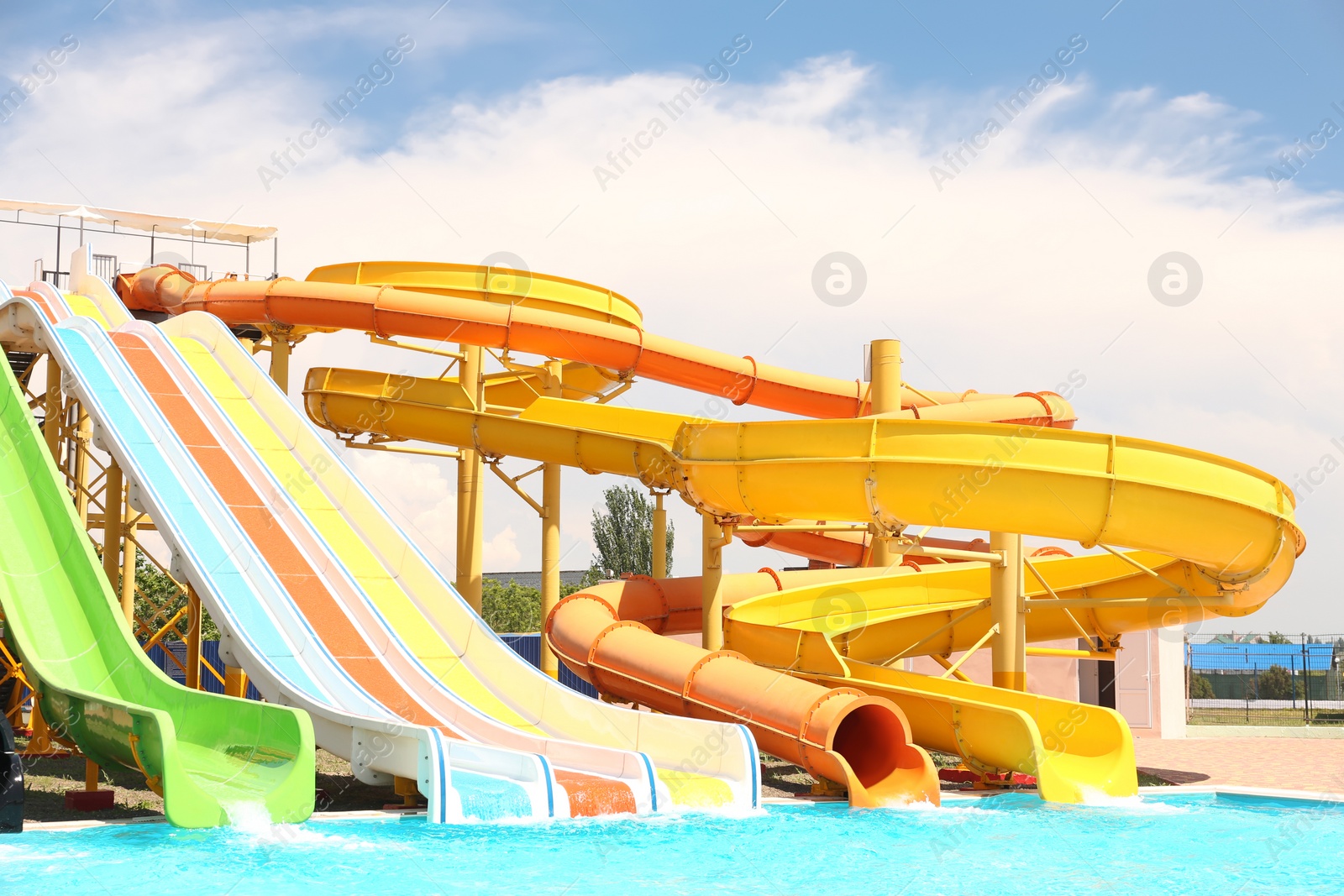 Photo of Different colorful slides in water park on sunny day