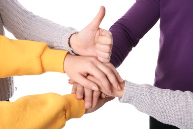 Photo of Group of people holding their hands together on white background, closeup