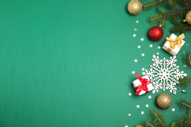 Photo of Flat lay composition with Christmas tree branches and festive decor on color background